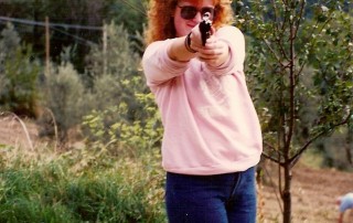 redhead with a gun, redhead woman pointing a gun